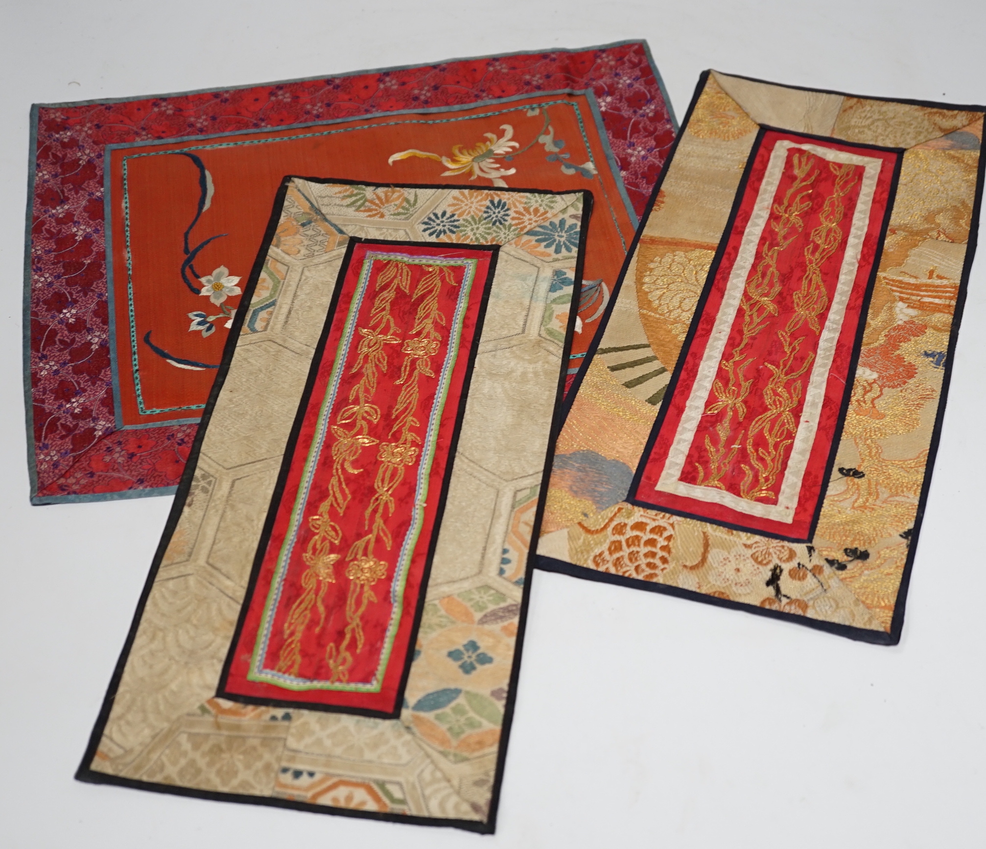 Nine Chinese silk embroidered panels, embroidered with gold thread and bordered with silk damask and brocade